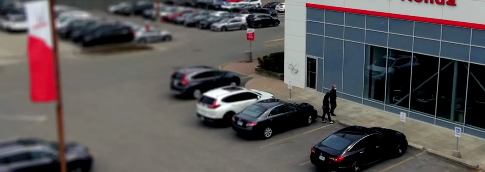 two customers walking into a car dealership