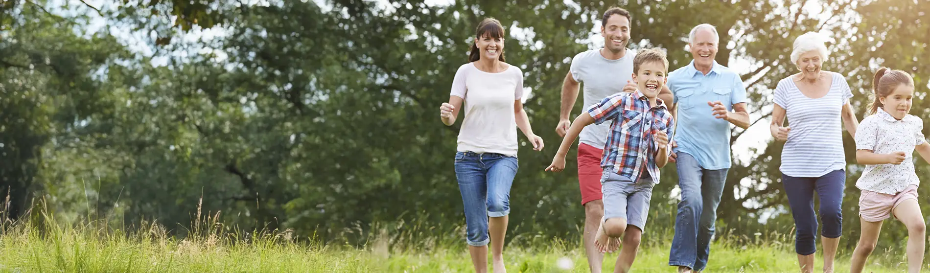 Multi Generation Family Running Across Field Together