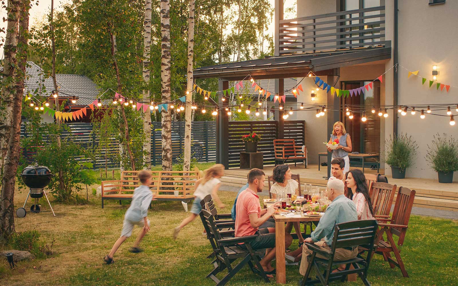 a big family eating a meal in a backyard