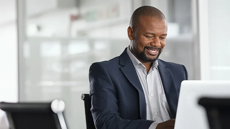 Smiling businessman working at computer