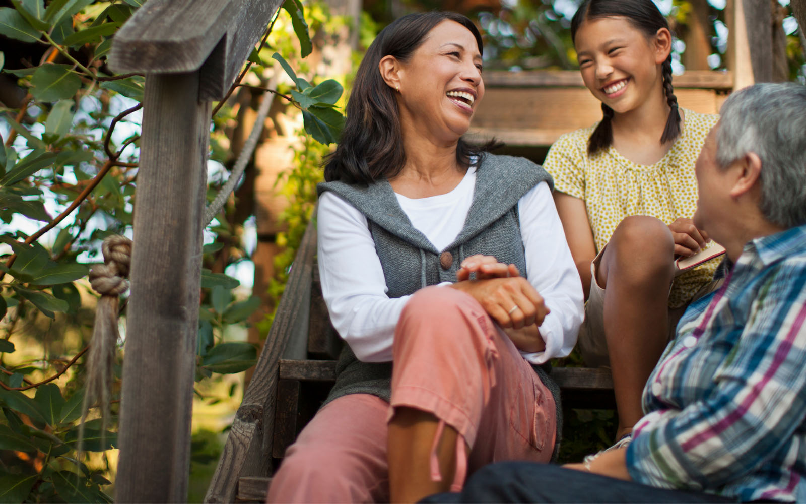 Family sitting talking amongst one another on steps