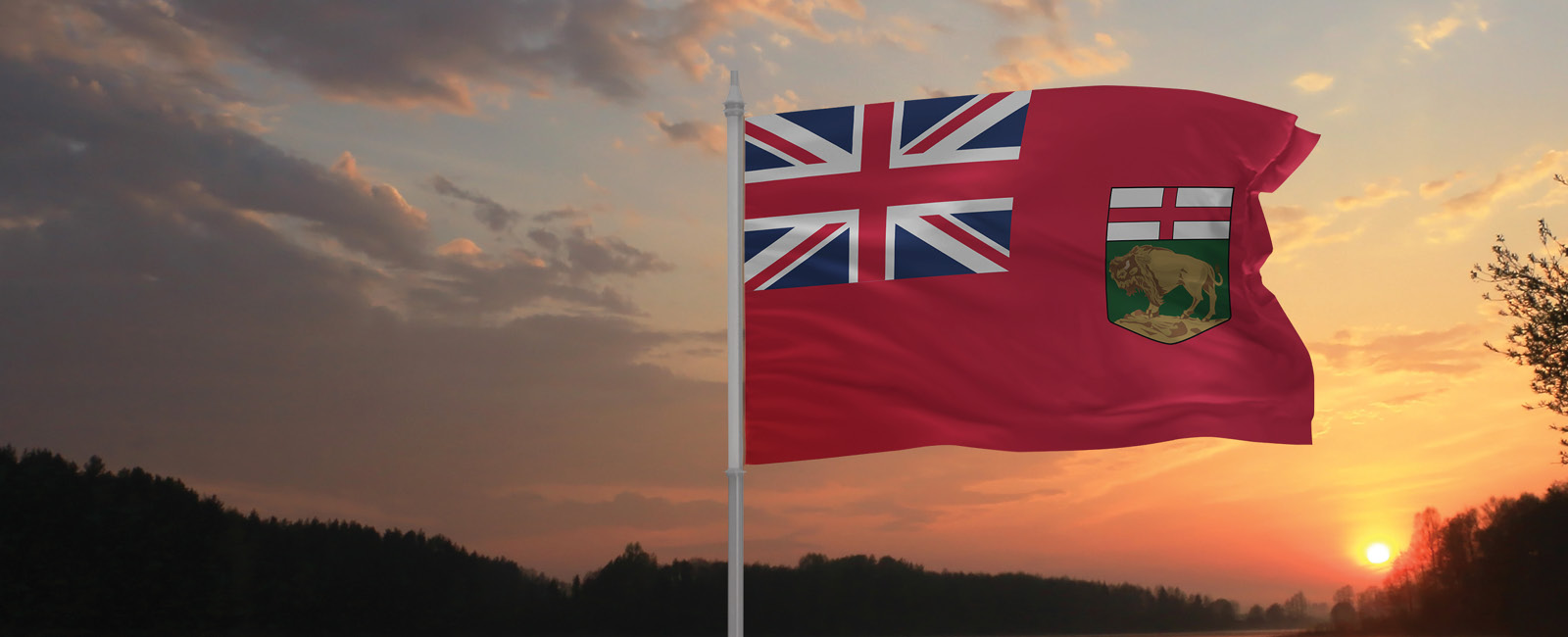 Manitoba flag flying in sunset