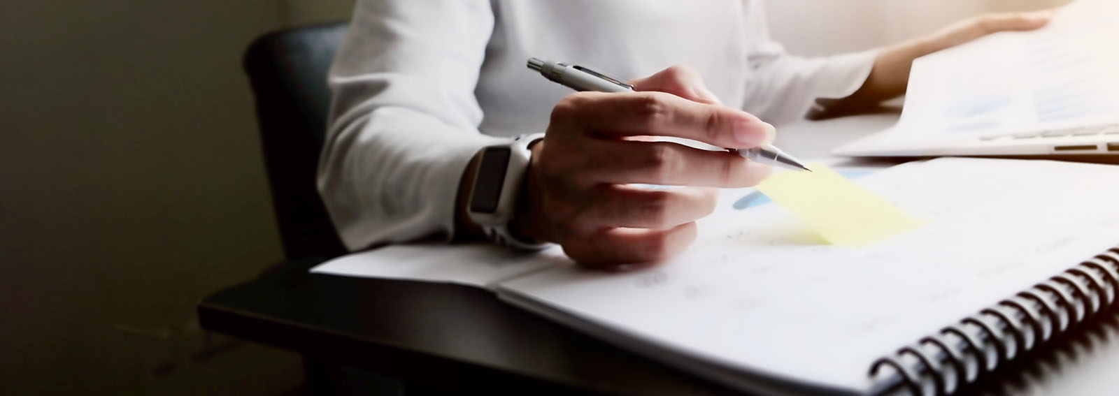 business woman reviewing tax deadlines on a calendar