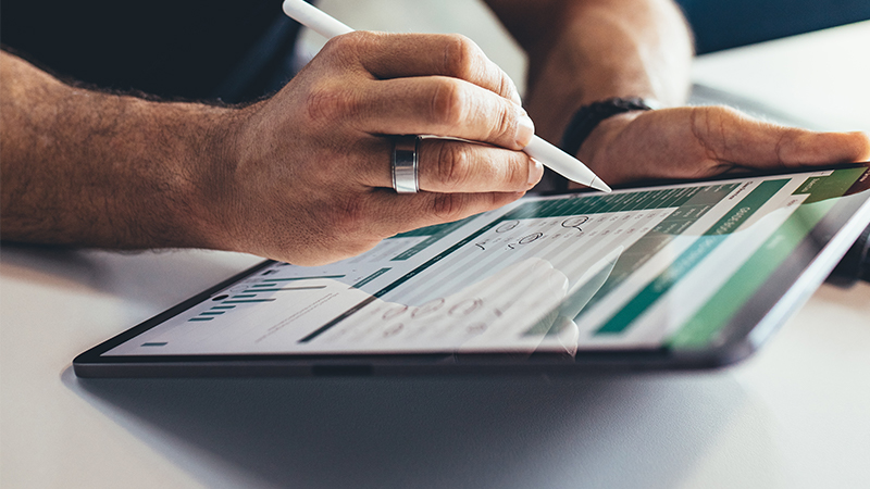 Businessman using stylus on tablet