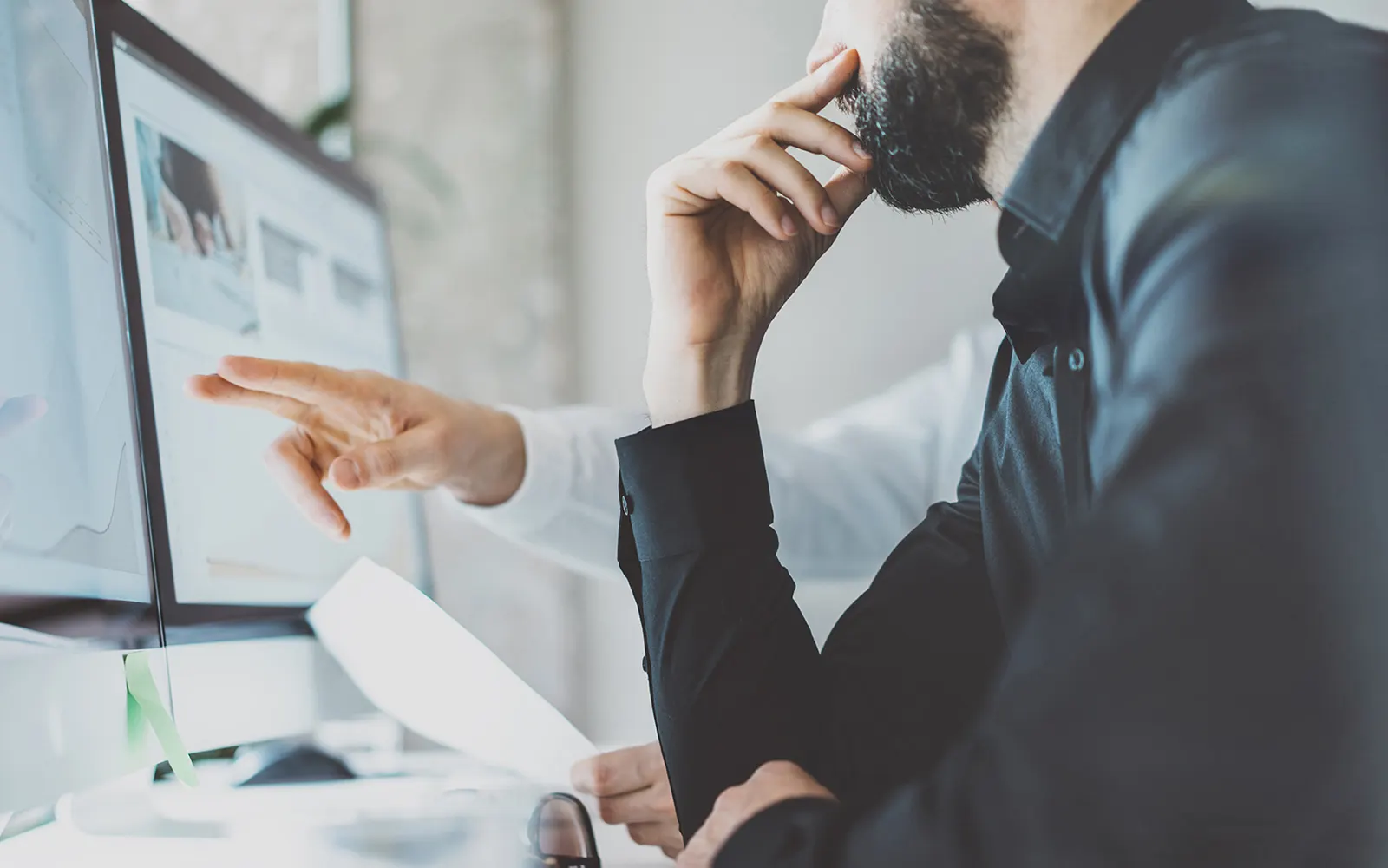 Two people working at a computer  