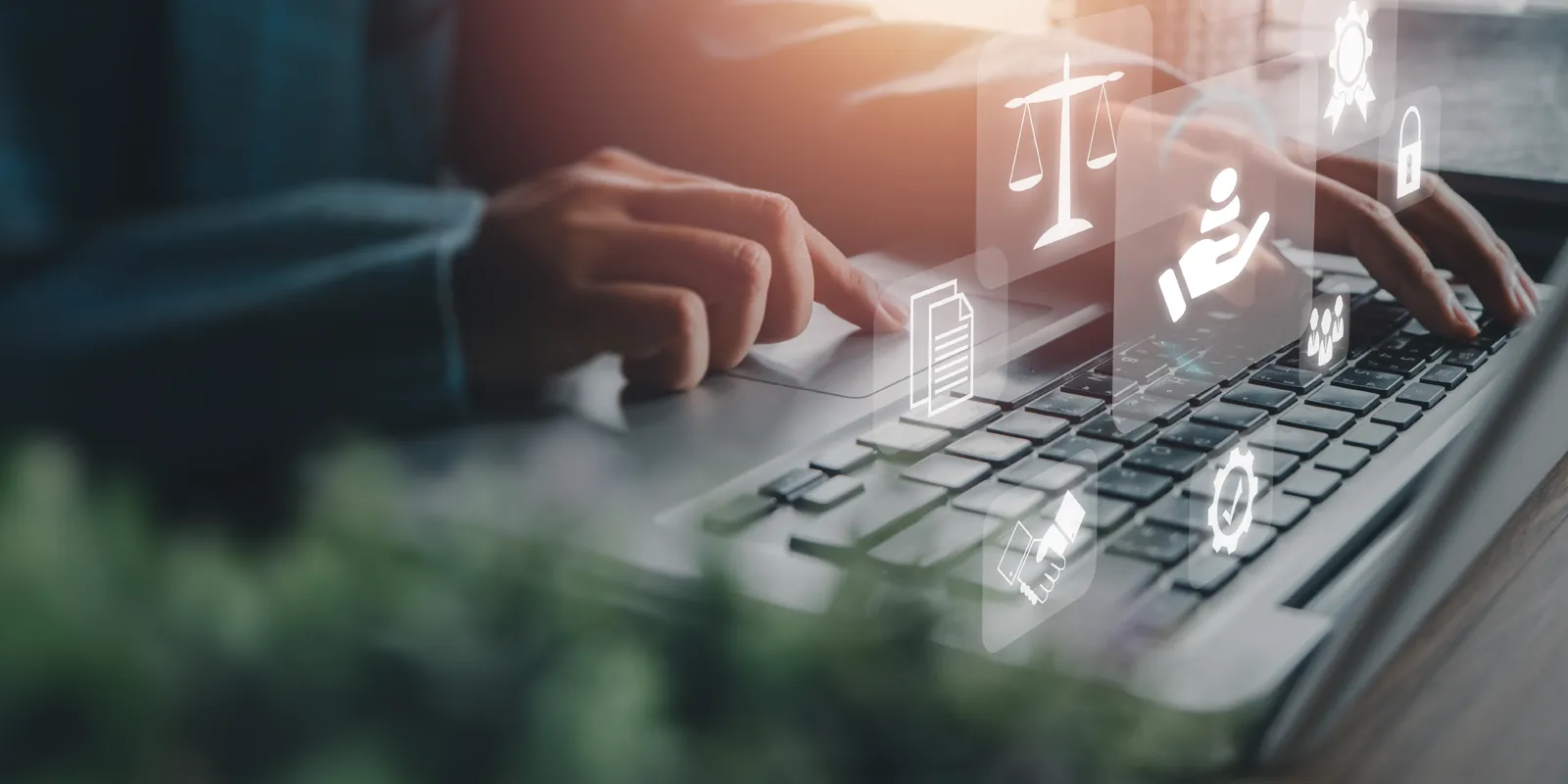 Buisiness advisor working on a laptop with legal icons overlaid